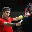 Roger Federer of Switzerland returns the ball to Milos Raonic of Canada during their quarterfinal match at the ATP World Tour Masters tennis tournament at Bercy stadium in Paris, France, Friday, Oct. 31, 2014. (AP Photo/Michel Euler)