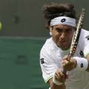 David Ferrer of Spain returns to Ivan Dodig of Croatia in their Men's singles match at the All England Lawn Tennis Championships in Wimbledon, London, Monday, July 1, 2013. (AP Photo/Anja Niedringhaus)