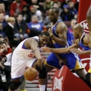 Golden State Warriors' Carl Landry, center, Jarrett Jack, right, and Philadelphia 76ers' Lavoy Allen (50) chase a loose ball in the first half of an NBA basketball game on Saturday, March 2, 2013, in Philadelphia. (AP Photo/H. Rumph Jr)