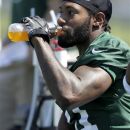 FILEm - This May 31, 2012 file photo shows New York Jets cornerback Antonio Cromartie drinking during NFL football practice in Florham Park, N.J. Cromartie hopes to play cornerback and wide receiver for the Jets this season. Cromartie participated in individual drills with the receivers for the first time during practice Monday, Aug. 13, 2012, running routes and catching passes.(AP Photo/Julio Cortez)