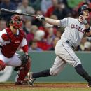Cleveland Indians' Jack Hannahan, right, watches his two-run home run in front of Boston Red Sox catcher Kelly Shoppach in the second inning of a baseball game in Boston, Thursday, May 10, 2012. (AP Photo/Michael Dwyer
