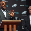 Six-time Pro Bowl quarterback Donovan McNabb, left, gestures as Philadelphia Eagles owner Jeffrey Lurie looks on, during a news conference in Philadelphia, on Monday July 29, 2013, announcing that McNabb will officially retire a member of the Eagles. McNabb played 11 of his 13 seasons with the Eagles, leading them to eight playoff appearances, five NFC East titles, five conference championship games and one Super Bowl loss. (AP Photo/ Joseph Kaczmarek)