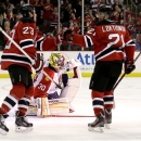 New Jersey Devils center David Clarkson (23) celebrates with Andrei Loktionov (21), of Russia, after Clarkson scored a goal on Florida Panthers goalie Scott Clemmensen, center, during the second period of an NHL hockey game, Saturday, March 23, 2013, in Newark, N.J. (AP Photo/Julio Cortez)
