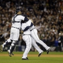 From left, Detroit Tigers' Gerald Laird, Phil Coke and Jhonny Peralta celebrate after winning Game 4 of the American League championship series 8-1, against the New York Yankees, Thursday, Oct. 18, 2012, in Detroit. The Tigers move on to the World Series. (AP Photo/Paul Sancya )