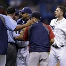 Tampa Bay Rays' Matt Joyce, right, is restrained after being hit by a sixth-inning pitch from Boston Red Sox starting pitcher John Lackey during a baseball game Monday, June 10, 2013, in St. Petersburg, Fla. Both benches emptied. (AP Photo/Chris O'Meara)