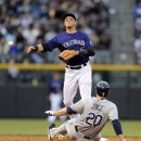 Colorado Rockies shortstop Troy Tulowitzki (2) throws to first after forcing out Tampa Bay Rays' Matt Joyce (20) at second, but does not complete the double play on Ben Zobrist during the third inning of a baseball game Saturday, May 4, 2013, in Denver. (AP Photo/Jack Dempsey)