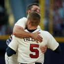 Atlanta Braves' Freddie Freeman is congratulated by teammate Dan Uggla after Freeman's bases loaded single scores the winning run during the ninth inning of their baseball game against the San Francisco Giants at Turner Field, Saturday, June 15, 2013, in Atlanta. The Braves won 6-5. (AP Photo/David Tulis)