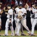 San Francisco Giants players celebrate after defeating the Cincinnati Reds 8-3 in Game 4 of the National League division baseball series, Wednesday, Oct. 10, 2012, in Cincinnati. (AP Photo/Michael Keating)