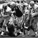 FILE - In this Dec. 20, 1970, file photo, Oakland Raiders' Ben Davidson (83) and Tom Keating, on ground, get to San Francisco 49ers quarterback John Brodie during an NFL football game in Oakland, Calif. The play was called back and San Francisco was penalized for illegal procedure. Davidson, the hulking defensive end who starred for the Raiders in the 1960s before becoming a famous television pitch man, died Monday, July 2, 2012. He was 72. (AP Photo/File)