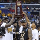 Wichita State's Carl Hall (22) and teammates pose with the regional trophy after defeating Ohio State 70-66 in the West Regional final in the NCAA men's college basketball tournament, Saturday, March 30, 2013, in Los Angeles. (AP Photo/Mark J. Terrill)