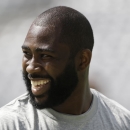 Tampa Bay Buccaneers cornerback Darrelle Revis smiles while warming up before an NFL football game against the New York Jets, Sunday, Sept. 8, 2013, in East Rutherford, N.J. (AP Photo/Julio Cortez)