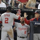 Washington Nationals' Denard Span (2) is greeted at the dugout by Danny Espinosa (8) and manager Davey Johnson, right, after scoring from third on a Ryan Zimmerman fly ball in the sixth inning of a baseball game against the Atlanta Braves in Atlanta, Friday, May 31, 2013. (AP Photo/John Bazemore)
