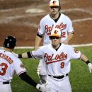 Baltimore Orioles' Nate McLouth (9) celebrates his two-run home run with Mark Reynolds, rear, and Manny Machado (13) during the eighth inning of a baseball game against the Chicago White Sox, Monday, Aug. 27, 2012, in Baltimore. The Orioles won 4-3. (AP Photo/Nick Wass)