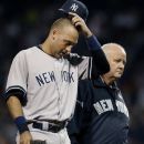 New York Yankees' Derek Jeter leaves the game with team trainer Steve Donohue after he was injured trying to beat out a grounder during the eighth inning of a baseball game against the Boston Red Sox at Fenway Park in Boston Wednesday, Sept. 12, 2012. (AP Photo/Elise Amendola)