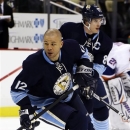 Pittsburgh Penguins' Jarome Iginla (12) and center Sidney Crosby warm up before an NHL hockey game against the New York Islanders in Pittsburgh, Saturday, March 30, 2013. (AP Photo/Gene J. Puskar)