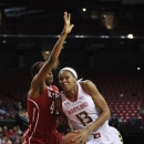 Maryland 's Alicia DeVaughn, right, drives to shoot as North Carolina State's Kody Burke defends in the first half of an NCAA college basketball game on Thursday, Jan. 17, 2013, in College Park, Md. (AP Photo/Gail Burton)