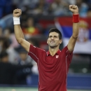 Novak Djokovic of Serbia celebrates his win over David Ferrer of Spain during their men's singles quarterfinal match of Shanghai Masters Tennis Tournament in Shanghai, China, Friday, Oct. 10, 2014. (AP Photo/Vincent Thian)