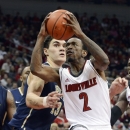 Louisville's Russ Smith (2) drives around the defense of Pittsburgh's Steven Adams during the second half of their NCAA college basketball game, Monday, Jan. 28, 2013, in Louisville, Ky. Louisville won 64-61. (AP Photo/Timothy D. Easley)