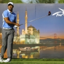 Tiger Woods of the United States watches the flight of his tee shot from the18th tee during the first round of the Turkish Open golf tournament at the Montgomerie Maxx Royal Course in Antalya, Turkey, Friday, Nov. 8, 2013. An image of Istanbul's Ortakoy Mosque and Bosporus Bridge are in the background.(AP Photo/Kaan Soyturk)