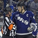 Tampa Bay Lightning center Vincent Lecavalier (4) talks to referee Kyle Rehman (37) during the second period of an NHL hockey game against the Toronto Maple Leafs Wednesday, April 24, 2013, in Tampa, Fla. (AP Photo/Chris O'Meara)