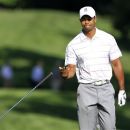 Tiger Woods throws his club after hitting to the 13th green from the fairway during the first round of the Memorial golf tournament at the Muirfield Village Golf Club in Dublin, Ohio, Thursday, May 31, 2012. (AP Photo/Tony Dejak)