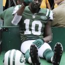 New York Jets wide receiver Santonio Holmes (10) gestures to fans as he is carted off the field after being injured during the second half of an NFL football game against the San Francisco 49ers Sunday, Sept. 30, 2012, in East Rutherford, N.J. (AP Photo/Bill Kostroun)
