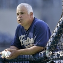 FILE - In this Sept. 23, 2013, file photo, San Diego Padres bench coach Rick Renteria prepares to pitch batting practice for the Padres' baseball game against the Arizona Diamondbacks in San Diego. The Chicago Cubs are set to hire Renteria as their manager, a person familiar with the situations said Wednesday, Nov. 6. (AP Photo/Lenny Ignelzi, File)