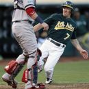 Oakland Athletics' Brandon Inge (7) slides into home plate to score a run past Boston Red Sox catcher Jarrod Saltalamacchia (39) in the third inning of a baseball game Saturday,  Sept. 1, 2012 in Oakland, Calif. (AP Photo/ Tony Avelar)
