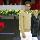 FILE - In this Dec. 1, 2011 file picture former tennis player Martina Hingis of Switzerland, right, and her husband Thibault Hutin walk prior a show jumping event at Villepinte, north of Paris. Martina Hingis has been questioned by Swiss police after her estranged husband said he was attacked by the five-time Grand Slam champion and her family. Schwyz canton police spokesman Florian Grossmann says Wednesday Oct 30, 2013 Hingis,her mother Melanie Molitor and her mother's boyfriend Mario Widmer were interviewed at its headquarters last week. Grossmann tells The Associated Press the canton justice department will decide possible further action. No timetable was set for a decision. French equestrian athlete Thibault Hutin has said he was attacked on Sept. 23 at his home in Feusisberg. Hutin claimed Hingis and Molitor hit him, and Widmer struck him with a DVD player. (AP Photo/Francois Mori, File)