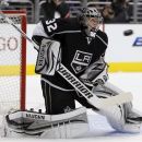 Los Angeles Kings goalie Jonathan Quick (32) keeps his eyes on the puck to make a stop against the Vancouver Canucks during the first period of Game 3 in a first-round NHL Stanley Cup playoff series in Los Angeles, Sunday, April 15, 2012.  (AP Photo/Alex Gallardo)