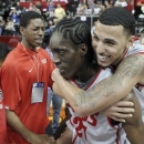 New Mexico's Kendall Williams, right, rides on the back of Tony Snell after New Mexi;co defeated UNLV 63-56 in an NCAA college basketball game for the Mountain West Conference men's tournament title, Saturday, March 16, 2013, in Las Vegas. (AP Photo/Isaac Brekken)