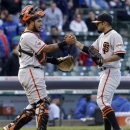 San Francisco Giants closer Sergio Romo, right, celebrates with catcher Hector Sanchez after defeating the Chicago Cubs 10-7 in a baseball game in Chicago, Sunday, April 14, 2013. (AP Photo/Nam Y. Huh)