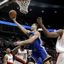 Golden State Warriors guard Klay Thompson goes to the hoop past Portland Trail Blazers center J.J. Hickson (21) during the first quarter of an NBA preseason basketball game in Portland, Ore., Friday, Oct. 19, 2012. (AP Photo/Don Ryan)