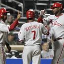 Philadelphia Phillies' Ryan Howard (6) celebrates with teammates Michael Martinez (7), Jimmy Rollins (11), and Juan Pierre (10) after hitting a grand slam during the ninth inning of a baseball game against the New York Mets on Thursday, Sept. 20, 2012, in New York. The Phillies won 16-1. (AP Photo/Frank Franklin II)