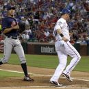 Cleveland Indians' Ubaldo Jimenez watches as Texas Rangers' Michael Young scores on a wild pitch by Jimenez in the second inning of a baseball game Tuesday, Sept. 11, 2012, in Arlington, Texas. (AP Photo/Tony Gutierrez)