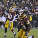 Washington Redskins quarterback Robert Griffin III (10) reacts as running back Alfred Morris (46) heads for a touchdown during the second half of an NFL football game against the Dallas Cowboys on Sunday, Dec. 30, 2012, in Landover, Md. (AP Photo/Richard Lipski)