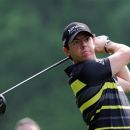 Northern Ireland's Rory McIlroy watches his shot on the 3rd hole during day one of the BMW PGA Championship at Wentworth Golf Club, Wentworth, England Thursday May 24, 2012.  (AP Photo/Steve Parsons/PA Wire)  UNITED KINGDOM OUT NO SALES NO ARCHIVE