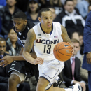 Connecticut's Shabazz Napier, right, is pursued by Providence's Kris Dunn during the second half of Connecticut's 63-59 overtime win in an NCAA college basketball game in Storrs, Conn., Saturday, March 9, 2013. (AP Photo/Fred Beckham)