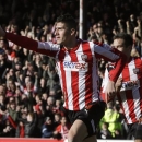 Brentford's Marcello Trotta celebrates after scoring against Chelsea, during their English FA Cup fourth round soccer match in London, Sunday, Jan. 27, 2013. The match ended 2-2 draw. (AP Photo/Lefteris Pitarakis)