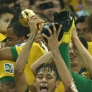 Brazil's Neymar, center, lifts the trophy after winning the soccer Confederations Cup final between Brazil and Spain at the Maracana stadium in Rio de Janeiro, Brazil, Sunday, June 30, 2013. (AP Photo/Bruno Magalhaes)