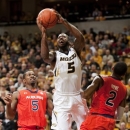 Missouri's Keion Bell, center, is fouled as he shoots between Auburn's Allen Payne, right, and Shaquille Johnson, left, during the first half of an NCAA college basketball game Saturday, Feb. 2, 2013, in Columbia, Mo. (AP Photo/L.G. Patterson)