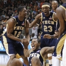 Georgia Tech's Marcus Georges-Hunt, on ground, celebrates with teammates Stacey Poole Jr. (12) and Brandon Reed (23) after Tech's game-winning basket during an NCAA college basketball game against Miami in Coral Gables, Fla., Wednesday, March 6, 2013. Georgia Tech won 71-69. (AP Photo/Luis M. Alvarez)