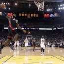 Miami Heat's LeBron James (6) goes up for a dunk against the Golden State Warriors during the first half of an NBA basketball game in Oakland, Calif., Wednesday, Jan. 16, 2013. James on Wednesday became the youngest player in NBA history to score 20,000 points. (AP Photo/Marcio Jose Sanchez)