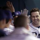 Tampa Bay Rays' Evan Longoria, right, high fives teammates in the dugout after his fourth-inning home run off Baltimore Orioles starting pitcher Chris Tillman during a baseball game Wednesday, Oct. 3, 2012, in St. Petersburg, Fla. (AP Photo/Chris O'Meara)