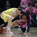 Penn State's Alex Bentley (20) reaches in for a loose ball around Michigan's Kate Thompson (12) during the first half of an NCAA college basketball game in State College, Pa., Sunday, Feb. 24, 2013. (AP Photo/Ralph Wilson)