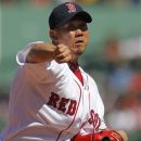Boston Red Sox starting pitcher Daisuke Matsuzaka delivers a pitch against the Kansas City Royals in the first inning of a baseball game at Fenway Park, Monday, Aug. 27, 2012. (AP Photo/Steven Senne)