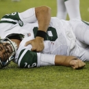 New York Jets quarterback Mark Sanchez (6) reacts to an injury during the second half of a preseason NFL football game against the New York Giants, Saturday, Aug. 24, 2013, in East Rutherford, N.J. He left the game with what appeared to be a shoulder injury. (AP Photo/Julio Cortez)