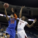 Florida forward Christin Mercer (25) drives to the basket as Arkansas forward Keira Peak (1) defends during the first half of an NCAA college basketball game at the Southeastern Conference tournament, on Thursday, March 7, 2013, in Duluth, Ga. (AP Photo/John Bazemore)