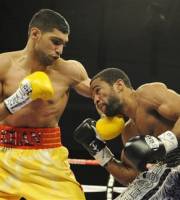 Amir Khan, left, of England, fights Lamont Peterson, right, during a boxing match, Saturday, Dec. 10, 2011, in Washington.