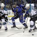 San Jose Sharks' Logan Couture, right, looks atthe loose puck as St. Louis Blues' Alex Pietrangelo, center, and Sharks' Ryane Clowe, left, look on during the first period of Game 1 of an NHL hockey first-round playoff series on Thursday, April 12, 2012, in St. Louis. (AP Photo/Jeff Roberson)